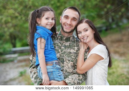 US army soldier with family in park
