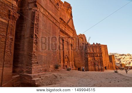 Petra Jordan - November 20 2010: Tourists walk in one of the Seven Wonders of the World - Red city of Petra in Jordan. Petra has been a UNESCO World Heritage Site since 1985