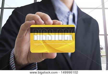 business man hand holding blank yellow credit card showing for concept banking and finance
