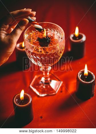 witch holds candle love spell on ritual