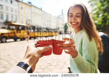 Woman In Green Sweater Drinking Coffee From Small Paper Cups With Boyfriend. Attractive Happy Smilin