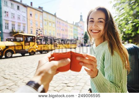 First Person View On A Woman In Green Sweater Drinking Coffee From Small Paper Cups With Boyfriend. 