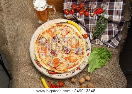 Pizza With Tomato, Cheese, Smoked Sausage, Boiled Sausage, Pepper Spices On A Wooden Tray, With Beer