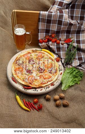 Pizza With Tomato, Cheese, Smoked Sausage, Boiled Sausage, Pepper Spices On A Wooden Tray, With Beer