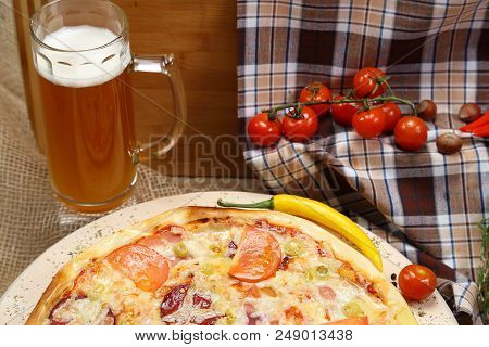 Pizza With Tomato, Cheese, Smoked Sausage, Boiled Sausage, Pepper Spices On A Wooden Tray, With Beer