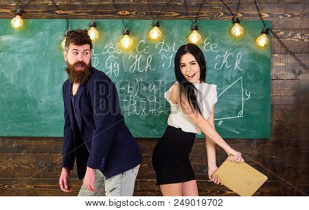 Student Lady Slapping On Teachers Buttocks With Book. Role Games Concept. Man With Beard Punished By