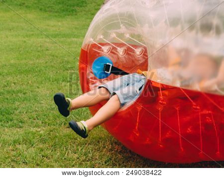 People Play Bumperball Zorbsoccer Outdoor. Summer Time