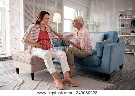 Mother Visit. Caring Concerned Mother Feeling Disturbed While Coming To Her Expecting Daughter Feeli