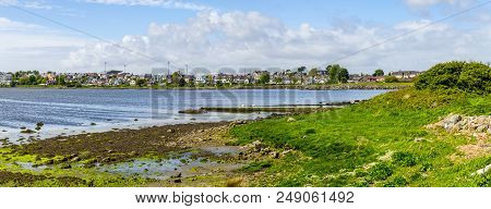 Lough Atalia Bay With Houses In Background And Cloud Reflection