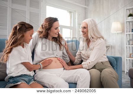 Visiting Mother. Good-looking Pregnant Woman Coming To Her Mother With Older Little Cute Daughter