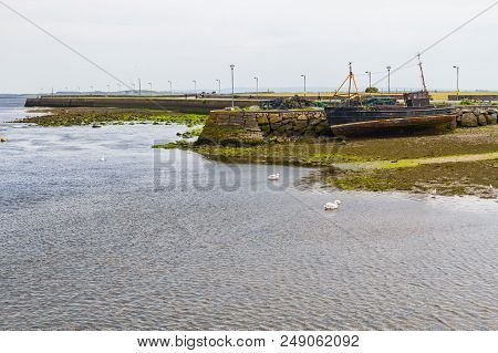 Pier With Stucked Boat In Corrib River