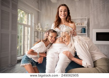 Cute People. Cute Appealing Grandmother And Daughter Leaning On Pregnant Smiling Woman