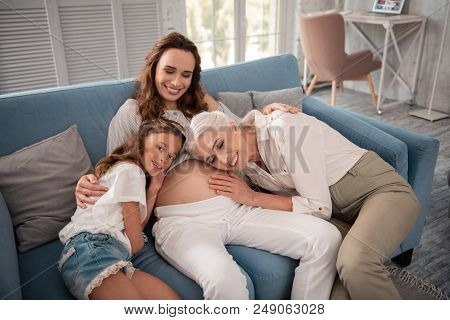 Light Room. Pregnant Good-looking Woman Feeling Calm And Nice Sitting In Light Room With Creative De
