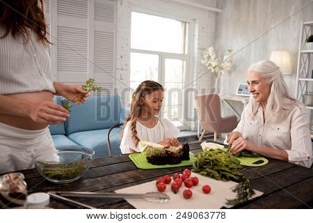 Cooking Lunch. Beautiful Cute Little Girl Feeling Interested While Joining Her Grandmother Cooking L