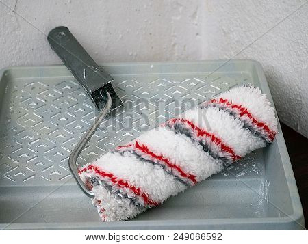 Paint Roll Brush And White Paint In Plastic Tray, House Renovation Concept