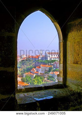 View through a window of São Jorge Castle on the hills of Lisbon, Portugal, in summertime.