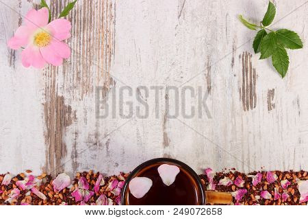 Frame Of Dried Wild Rose Petals, Tea Grains And Cup Of Tea, Copy Space For Text Or Inscription On Ru