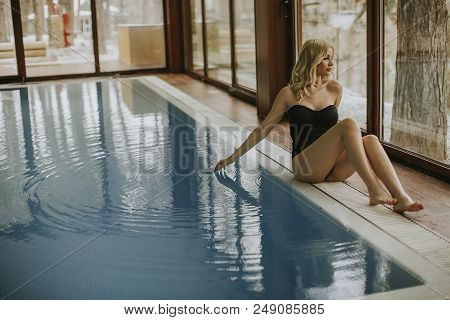 Pretty Young Woman Relaing By The Swimming Pool