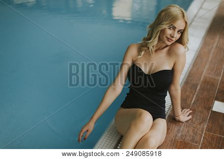 Pretty Young Woman Relaing By The Swimming Pool