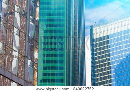 Angle Glass Red, Burgundy, Brown, Green, Aqua Clolrs Facades Of A Window Of Financial Skyscrapers, A