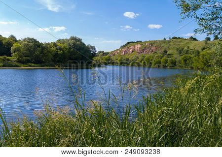 A Big Beautiful River Bay On The Background Of A Green Rocky Mountain