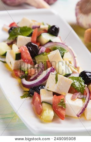 Greek salad with feta cheese cubes and fresk vegetables
