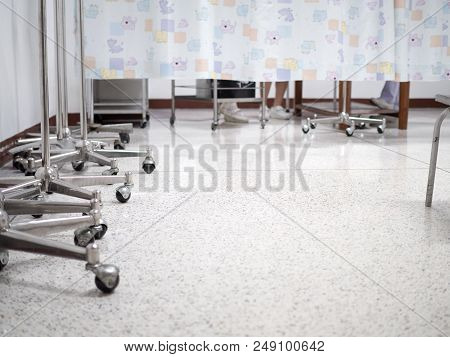 Nurse Working With Patient Behind The Curtain