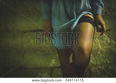 Prostitute With Cigarette Working On The Night Street.