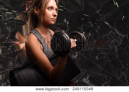 Young Beautiful Woman Doing Biceps Curl With Ez Curl Bar In A Gym. Athletic Girl Doing Workout In A 