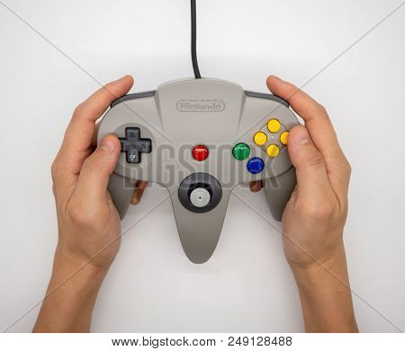 Nintendo64 : Bangkok, Thailand - July 12, 2018 : Hand Hodling The Grey Nintendo 64 Game Controller I
