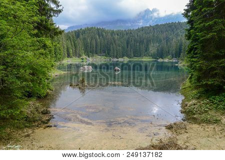 Lake Carezza With Reflection Of Mountains In The Dolomites