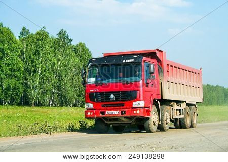 Uvildy, Russia - July 12, 2008: Red Dump Truck Cnhtc Howo At The Interurban Dirt Road.