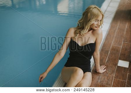 Pretty Young Woman Relaing By The Swimming Pool