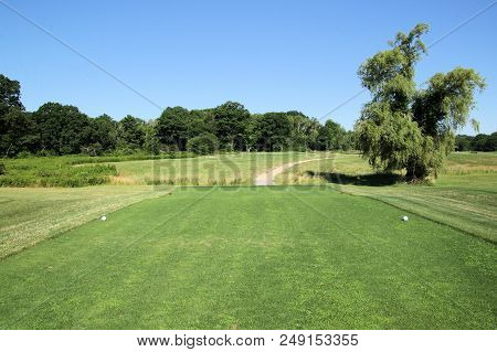 Short Par 3 Golf Hole Under Beautiful Sunny Summer Skies.