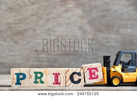 Toy Forklift Hold Letter Block E To Complete Word Price On Wood Background