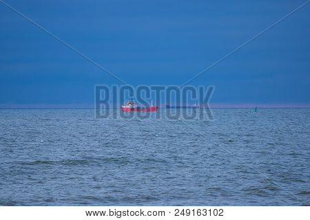Ships Standing In The Roadstead.
Slightly Wavy Surface Of The Sea. Small Waves Ripple The Surface Of
