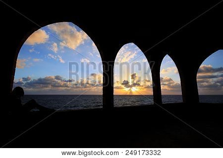 Silhouette Of A Girl Contemplating A View Of The Mediterranean Sea Through Arches In Batroun, Lebano