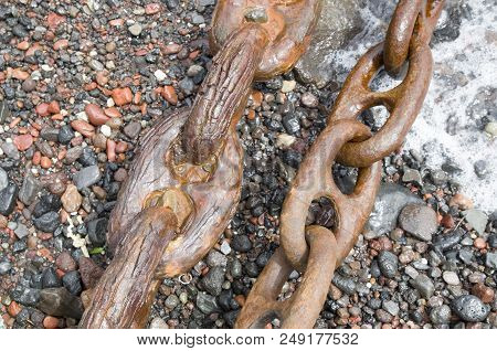 Two Old Rusty Shipping Chains On The Seashore