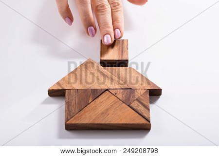 Woman Building House With Wooden Tangram Puzzle