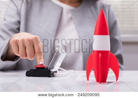 Businesswoman's Hand Launching Rocket
