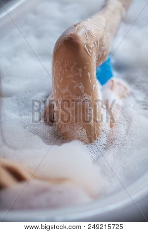 Wet Female'sl Egs In Foam. Wash Legs With Sponge