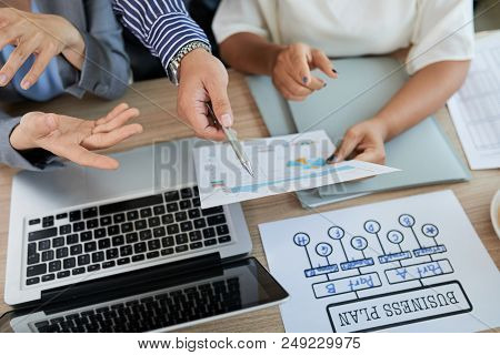 Hands Of Business Partners Discussing Charts And Diagrams With Financial Data