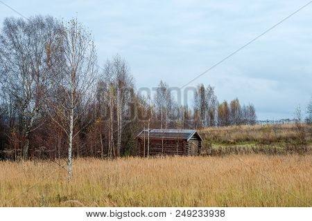 Wooden House Standing In A Thicket. Autumn Landscape.