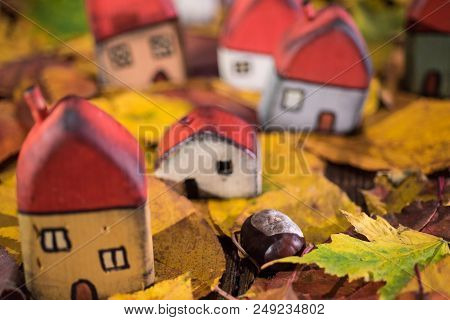 Painted Toy Houses On Autumn Leaves