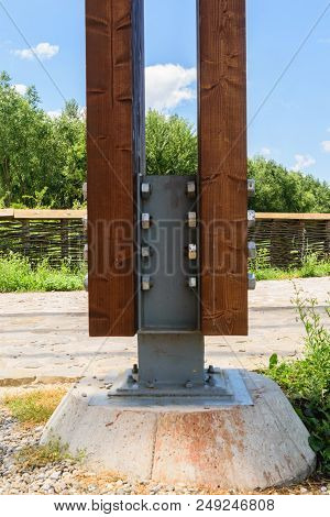 Detail Of Massive Wood Post Anchored With Special Metal Connector Using Nuts And Bolts To A Solid Is