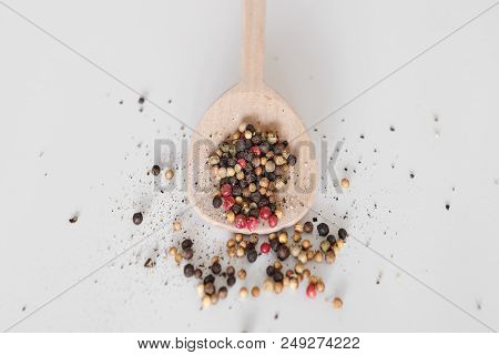 A Spoon With Peber Beans On White Background