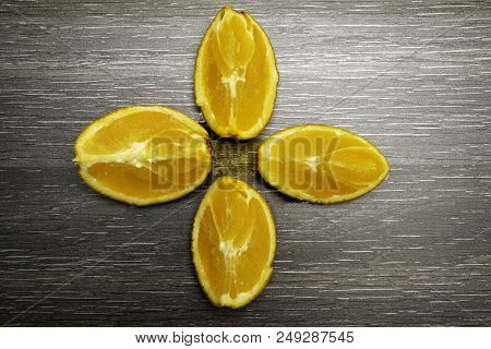 Orange Fruit. Four Orange Slice And Pieces Isolate On Black Wood.