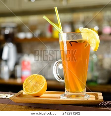 Hot Alcoholic Cocktail Grog With Slice Of Lemon And Straws At Glass At The Bar Counter, Selective Fo