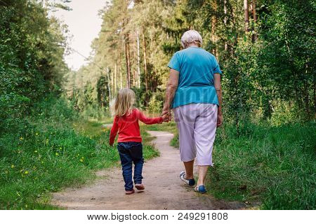Grandmother With Granddaughter Walk In Nature, Active Seniors