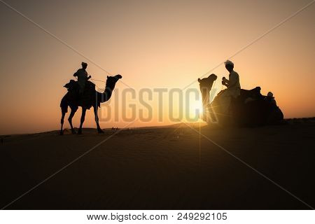 Rajasthan Travel Background - Three Indian Cameleers (camel Drivers) With Camels Silhouettes In Dune